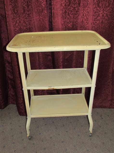 The utility cart's baskets are roomy enough to hold a lot of stuff. Lot Detail - VINTAGE METAL THREE TIER UTILITY CART