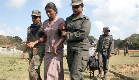 Women Soldiers Of The Sri Lankan Army Helping A Tamil War Refugee Get