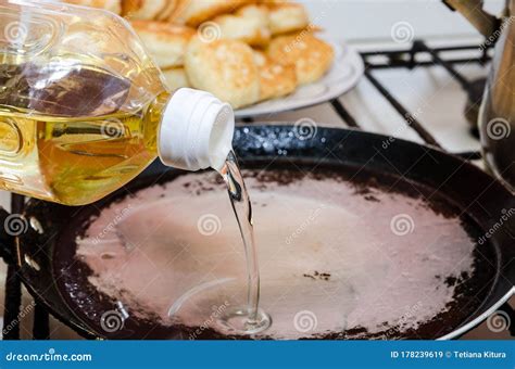 Pour Sunflower Oil Into A Hot Pan The Process Of Making Pancakes