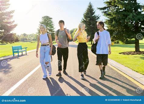 Outdoor Four Teenagers Walking Together On Road Stock Photo Image Of