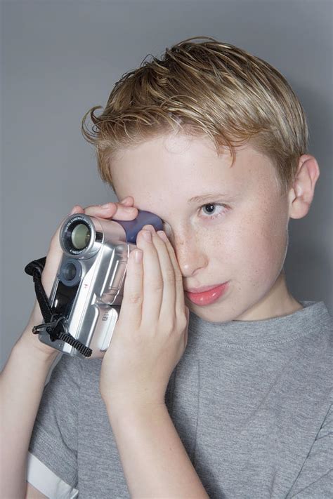 Boy Using A Digital Camcorder Photograph By Gustoimagesscience Photo