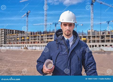 Civil Engineer In A White Helmet On The Background Of A Building Under