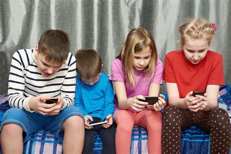 Children Playing Game On Mobile Phones Stock Photo Image Of