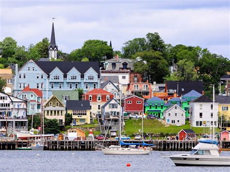 Boats Are In The Water Near Colorful Houses