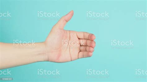 Empty Hand Holding Or Catch Nothing Guesture On Mint Green Or Ttiffany Blue Background Stock