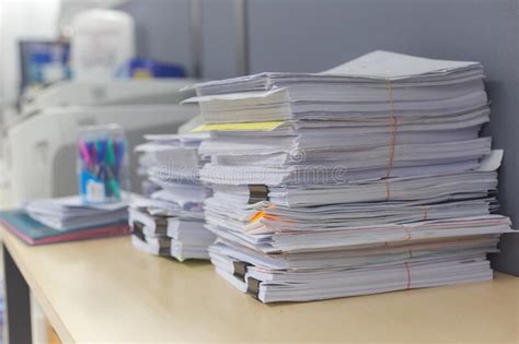 Pile Of Documents On Desk Stack Up High Waiting To Be Managed Stock