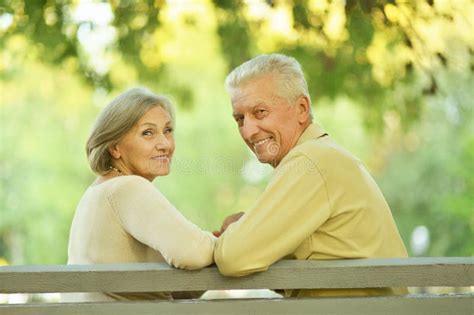 Couple Sitting On A Bench Stock Image Image Of Laughing 44999809