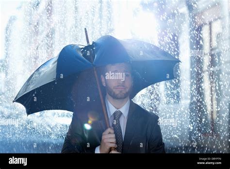 Frustrated Businessman With Broken Umbrella In Rain Stock Photo Alamy