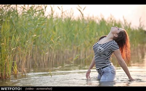 hot girl in wet striped t shirt and tight jeans swim on the lake wetlook one