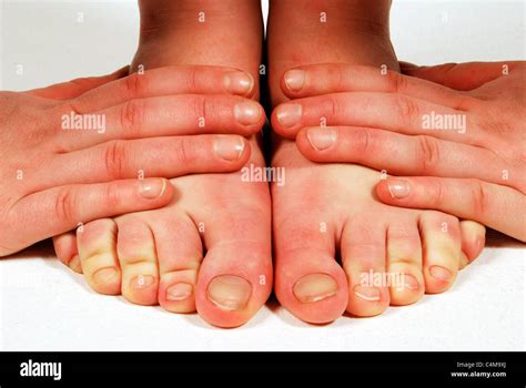 Hands On Feet Stock Photo Alamy