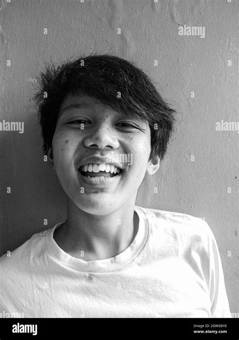 Portrait Of Smiling Boy Against Wall Stock Photo Alamy