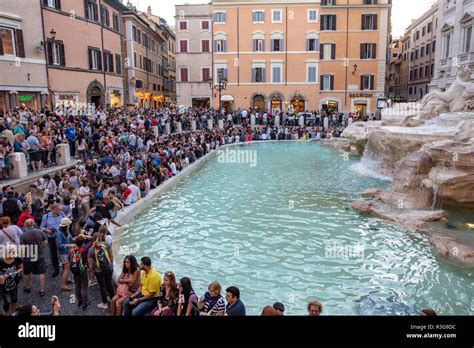 Tourists Crowd Around The Trevi Fountain In The Centre Of Romelazio