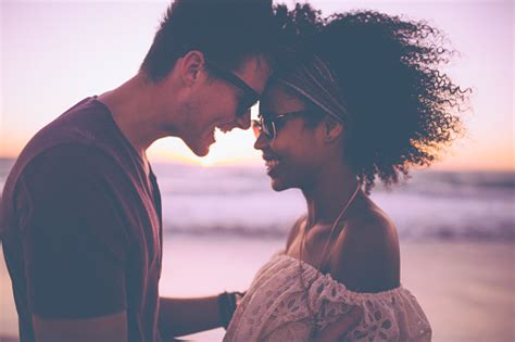Mixed Race Couple Sharing A Romantic Moment At Sunset Stock Photo