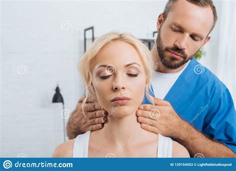 Portrait Of Massage Therapist Massaging Neck Of Young Woman Stock Image Image Of Indoors