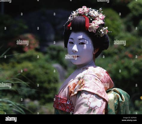 Girl In Maiko Trainee Geisha Costume In Japanese Garden Of Gion Kyoto Wearing Kimono Obi Wig