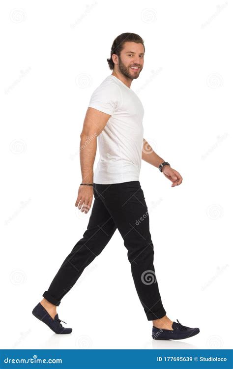Handsome Casual Man Is Walking Looking At Camera And Smiling Side