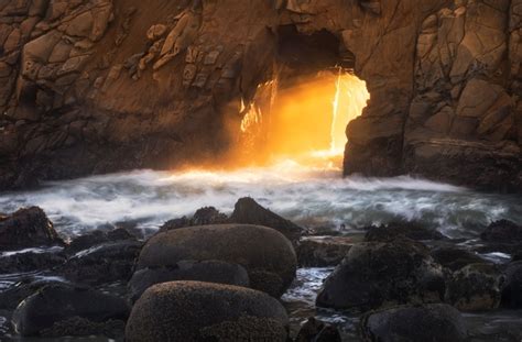 Warm Light Rays Shining Through Keyhole Rock At Pfeiffer Beach