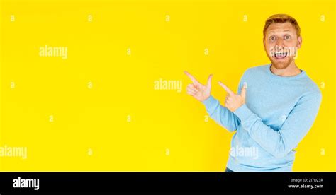 Young Adult Man Pointing With Finger Over Isolated Background With Copy