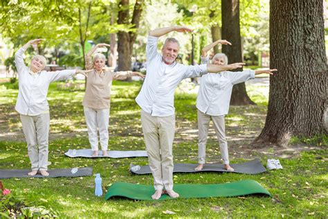 Joyful Mature People Doing Qigong Exercise In The Park Acacia Therapies