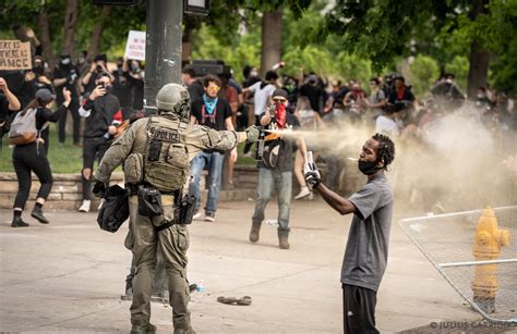 Defiance A Protester Calmly And Bravely Records The Riot Police In Close Range As He Gasses