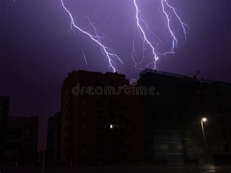 Lightning Bolts Light Up Sky In City During Storm At Night Stock Image