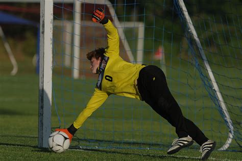 Ames Goalkeeper Ryan Mills Dives To Block The Ball Away From The Goal