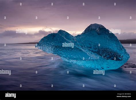 Translucent Blue Iceberg Washed Ashore On Breidamerkursandur Black