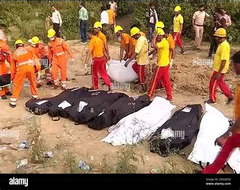 rescue team recovers victims bodies from a carriage wreckage of a three train collision in