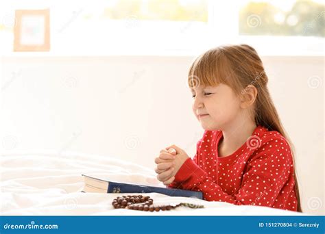 Little Girl With Bible Praying In Bedroom Stock Photo Image Of