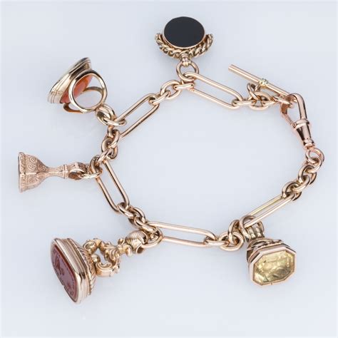 9k Rose Gold Fob Charm Bracelet With A Mixture Of Seals And Fobs Some