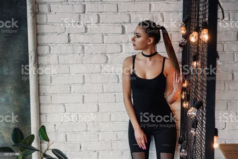 Portrait Of Amazing Stylish Young Woman Posing At Loft Style Room