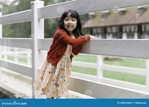 Adorable Asian Girl Playing Happily At The Playground Stock Image