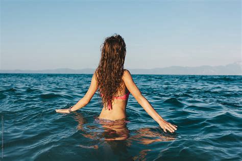 Babe Woman Entering The Sea And Looking At The Horizon Del Colaborador De Stocksy Aleksandar