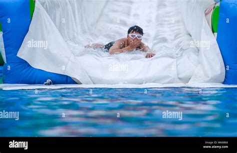 A Tourist Plays On Asias Longest Water Slide At Jingzhihu Resort In