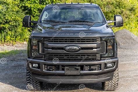 Black Ford Pickup Truck Parked In A Lush Green Grassy Field Editorial