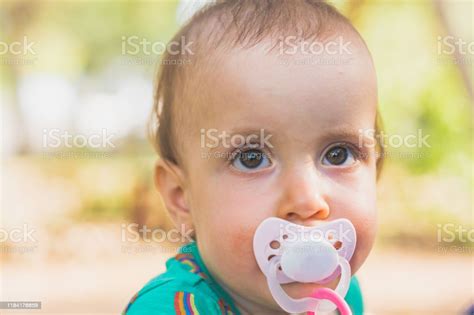 Portrait Of Little Baby Girl With Pacifier Stock Photo Download Image