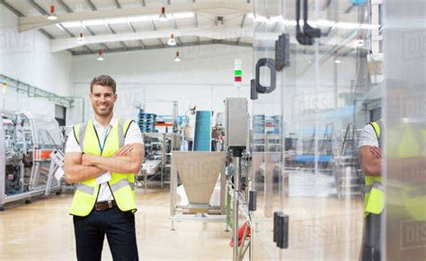 Worker Smiling In Factory Stock Photo Dissolve