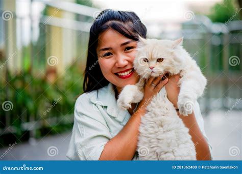 Woman Holding Cat Playing At Home With Love For Cats The Smile Glints