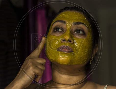 Image Of Close Up Of A Woman With Cosmetic Facial Mask All Over Her
