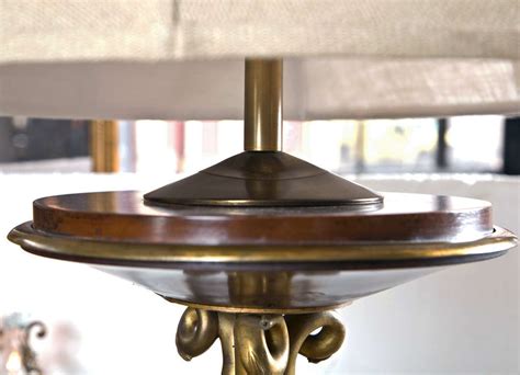 Our colee mahogany floor lamp has a lustrous ring of metal in an antique brass finish that connects two elongated pieces of rubber wood in a dark mahogany finish. French Bronze Empire Style Mahogany Floor Lamp at 1stdibs