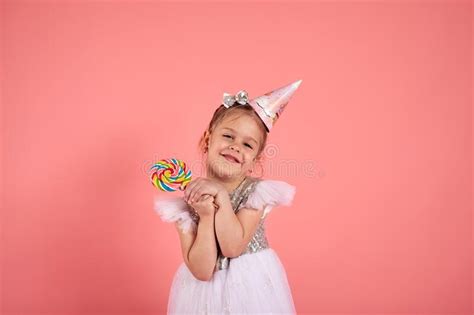 Happy Smiling Child With Tasty Lollipop Having Fun Over Pink Background