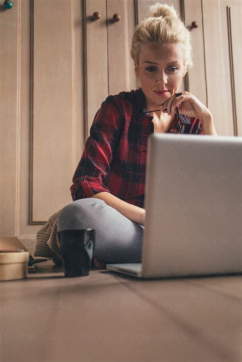 Blonde Woman Sitting On The Floor And Working On Her Laptop Del