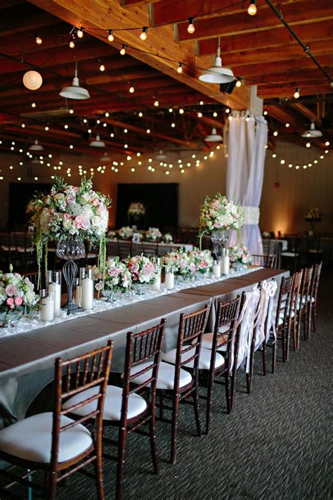 a long table with flowers and candles on it