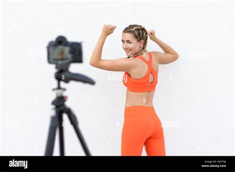 Young Fitness Blogger Taking A Selfie Video As She Demonstrates Various