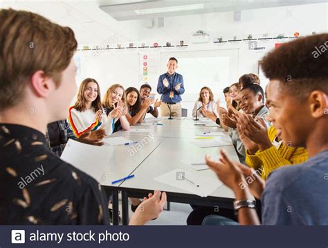 High School Students And Teacher Clapping For Student In Debate Class