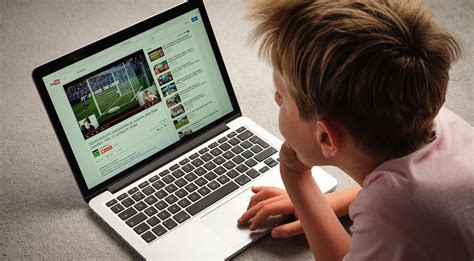 A Child Watching Youtube Videos On A Laptop Computer The Early