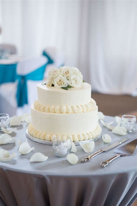 Carrot cake is a sweet and moist spice cake, full of cut carrots and toasted nuts, and covered in cream cheese icing. Two-Tier Round Wedding Cake with Buttercream Frosting