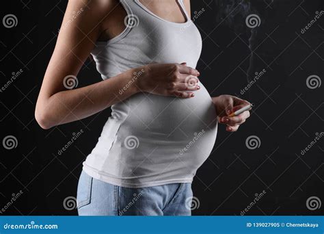 Pregnant Woman Smoking Cigarette On Black Closeup Space For Text