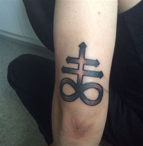 A Person With A Tattoo On Their Arm Has An Infinite Sign Tattooed On