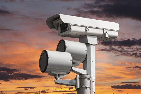Traffic intersection signal surveillance camera with sunset sky
